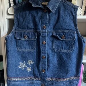 Blue denim vest with white embroidered flowers